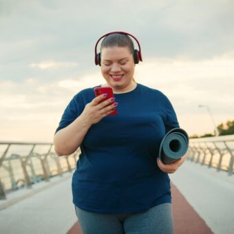 Outdoor Portrait of a Woman Using Red Smartphone